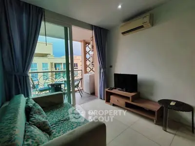 Modern living room with balcony view, featuring cozy sofa and air conditioning.