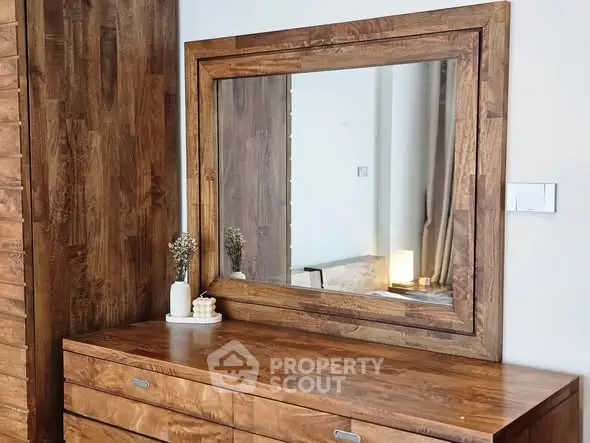 Elegant wooden dresser with mirror in a stylish bedroom setting.