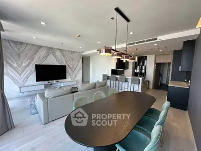 Luxurious open-plan living room with modern kitchen and stylish dining area in a contemporary apartment.