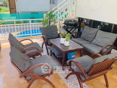 Charming outdoor patio with cozy seating and BBQ grill, perfect for entertaining.