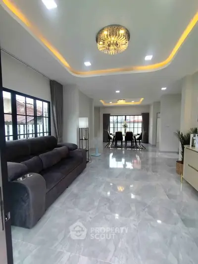 Spacious modern living room with elegant lighting and marble flooring