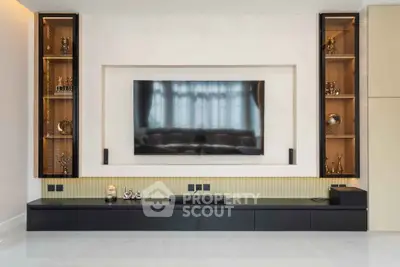 Modern living room with sleek entertainment center and large flat-screen TV.