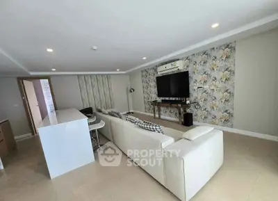 Spacious modern living room with stylish decor and open layout, perfect for relaxation and entertainment.