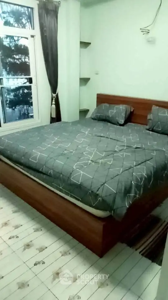 Cozy bedroom with large window and modern decor