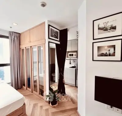 Chic modern bedroom with built-in wardrobe and compact kitchen area