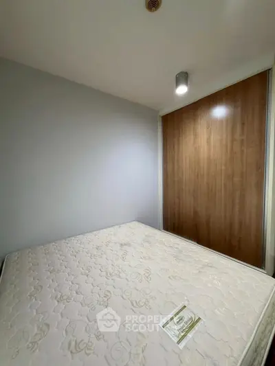 Cozy bedroom with minimalist design and wooden wardrobe