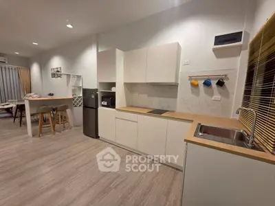 Modern kitchen with sleek cabinetry and open layout in stylish apartment
