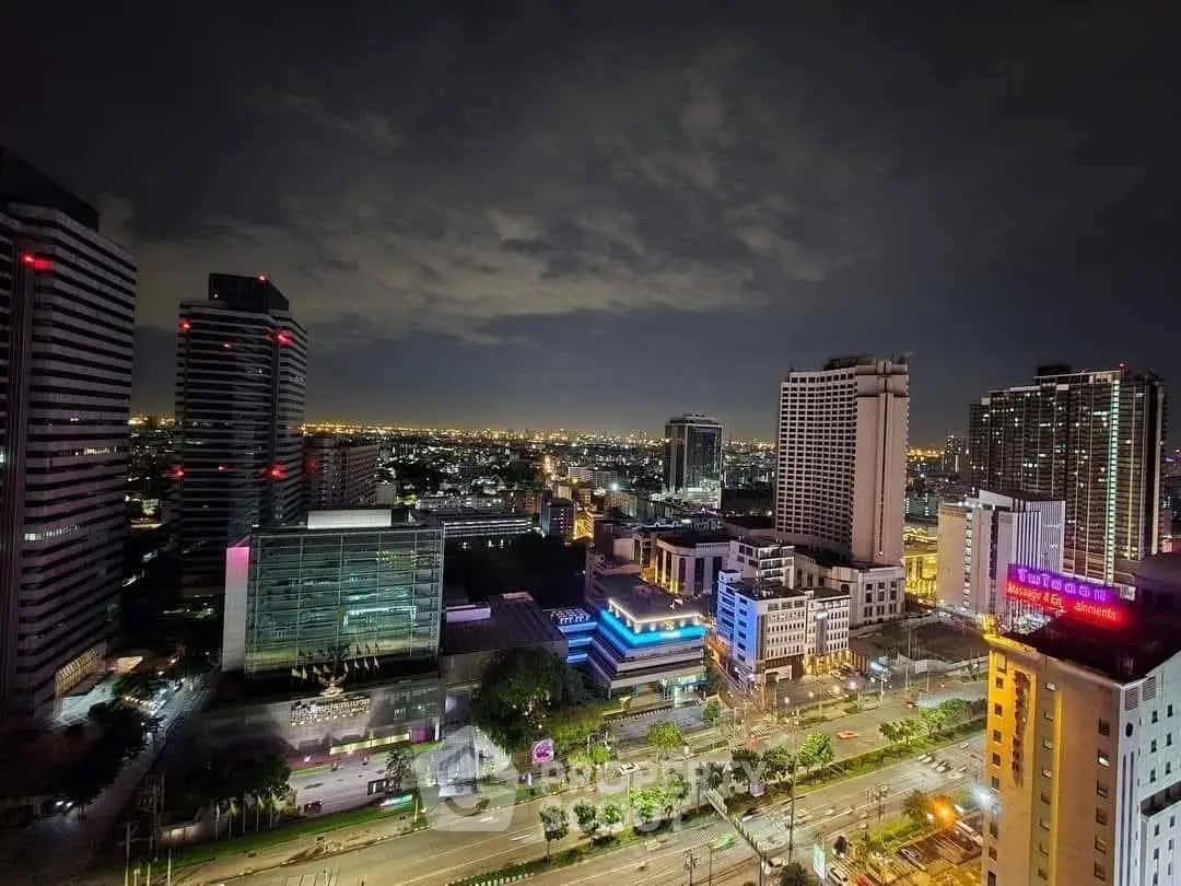 Stunning cityscape view from high-rise building at night with illuminated skyline.