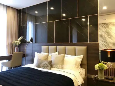 Luxurious bedroom with elegant decor and plush bedding in modern apartment.