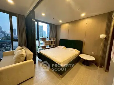 Modern bedroom with city view, featuring elegant decor and ample natural light.