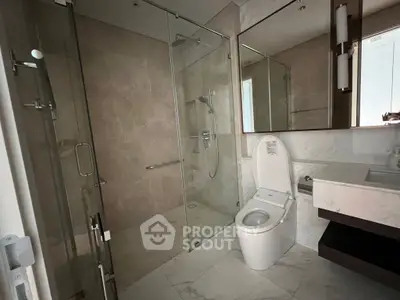 Luxurious modern bathroom with glass shower and elegant fixtures