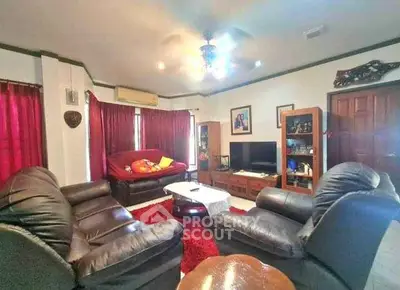 Spacious living room with cozy leather sofas and entertainment center