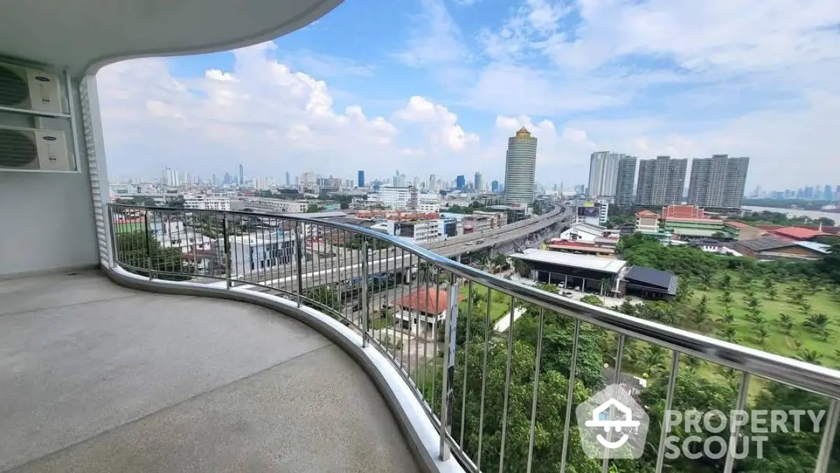 Stunning balcony view of city skyline with modern architecture and lush greenery.