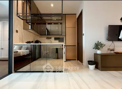 Modern open-layout kitchen with sleek cabinetry and integrated appliances in a stylish apartment.