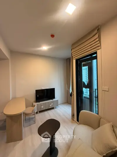 Modern living room with stylish furniture and balcony access in a high-rise apartment.