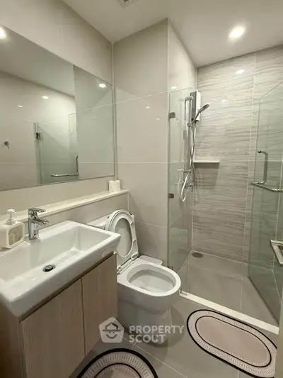 Modern bathroom with glass shower and sleek fixtures