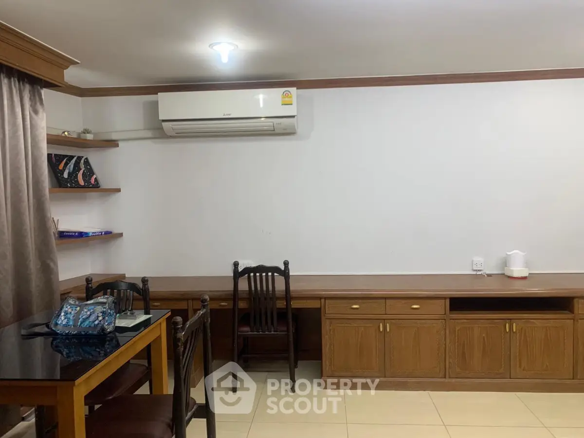 Cozy study room with wooden furniture and air conditioning