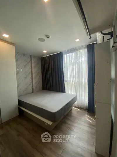 Modern bedroom with large window and elegant decor