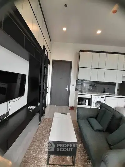 Modern living room with sleek furniture and integrated kitchen appliances