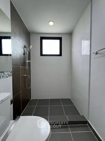 Modern bathroom with sleek tiles and walk-in shower design