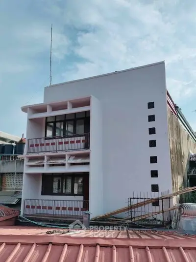 Modern minimalist building exterior with clean lines and unique architectural design.