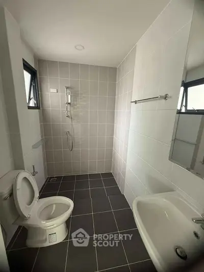 Modern minimalist bathroom with sleek fixtures and neutral tiles