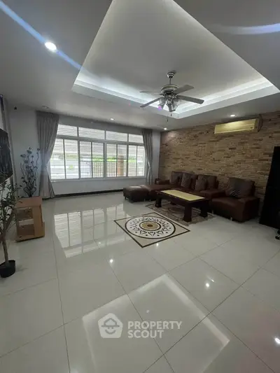 Spacious living room with modern decor and large windows
