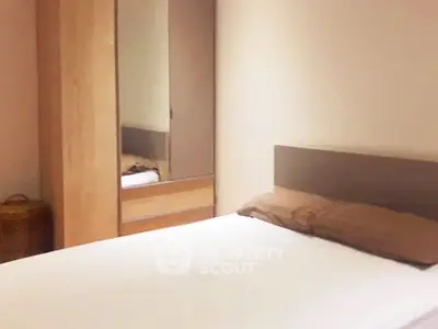 Cozy bedroom with minimalist design and wooden wardrobe