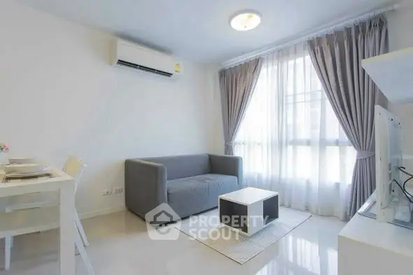 Modern living room with sleek furniture and natural light, perfect for urban living.