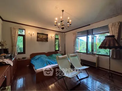 Charming bedroom with vintage decor and lush garden views