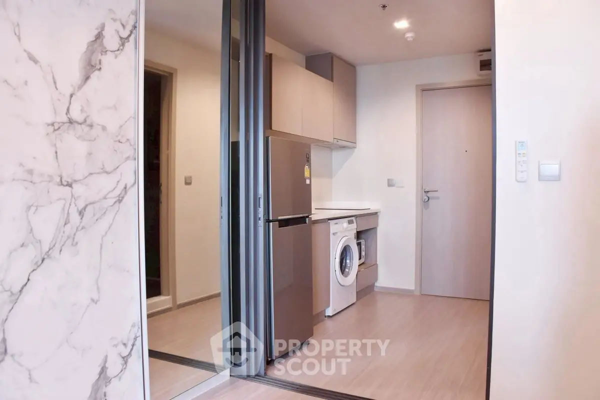 Modern apartment interior with sleek kitchen and washing machine