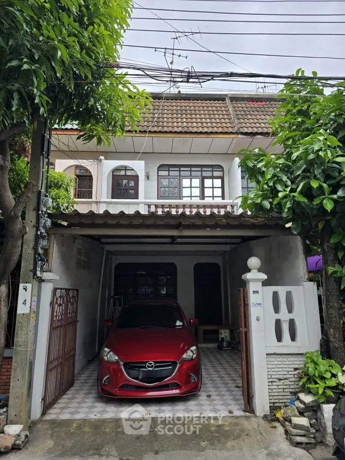 Charming townhouse with covered parking and lush greenery