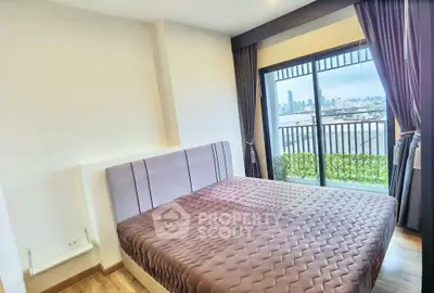 Modern bedroom with city view and balcony access in high-rise apartment