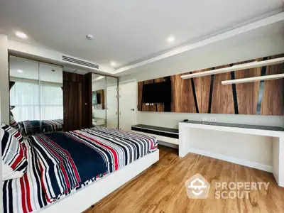 Modern bedroom with stylish decor and wooden flooring in a luxury apartment.