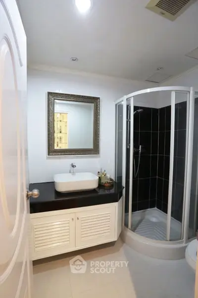 Modern bathroom with sleek shower and elegant vanity mirror