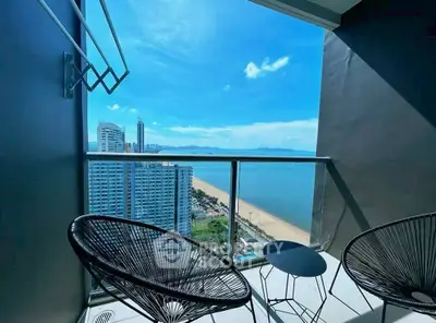 Stunning ocean view from modern balcony with stylish seating, perfect for relaxation.
