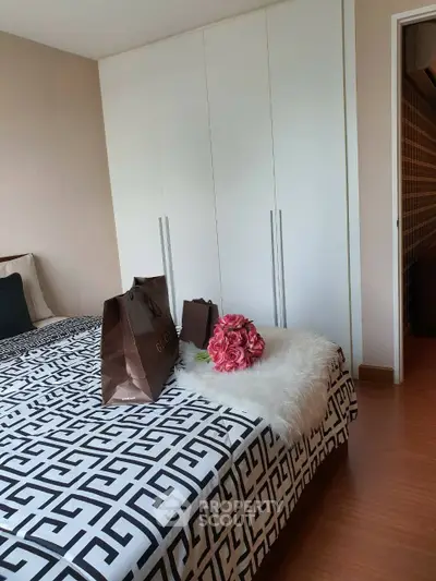 Stylish bedroom with modern decor and ample closet space, perfect for comfortable living.