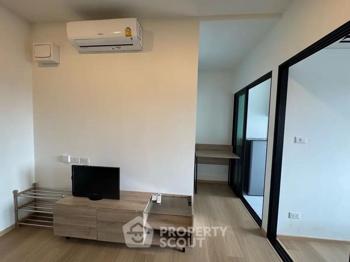 Modern living room with air conditioning and sleek wooden furniture