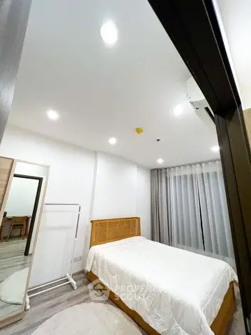 Modern bedroom with cozy lighting and stylish decor in a contemporary apartment.