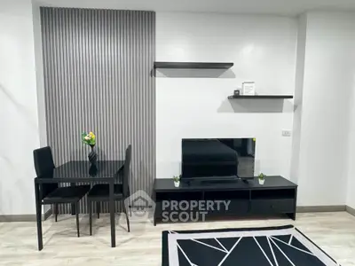 Modern living room with sleek black furniture and stylish decor