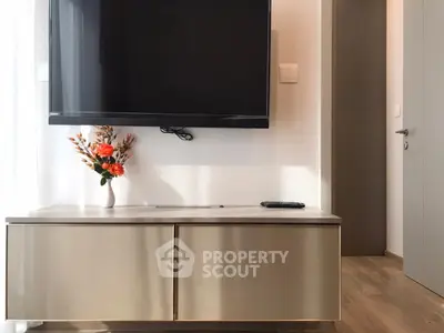 Modern living room with wall-mounted TV and sleek cabinet