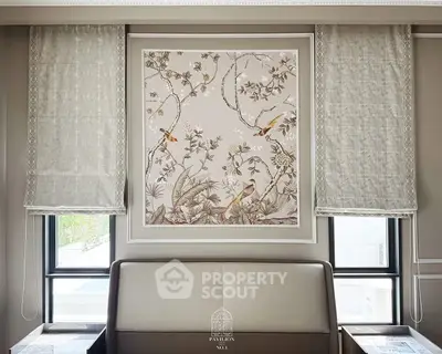 Elegant interior design with exquisite wall art and luxurious window treatments in a sophisticated living space.