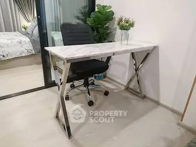 Modern study area with sleek desk and comfortable chair in stylish apartment.