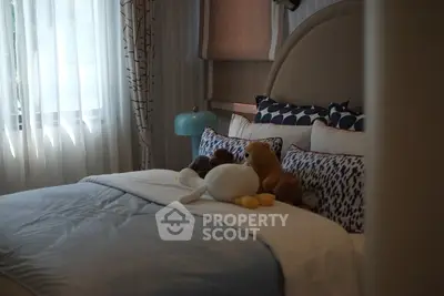 Cozy bedroom with plush toys and elegant decor, perfect for a serene retreat.