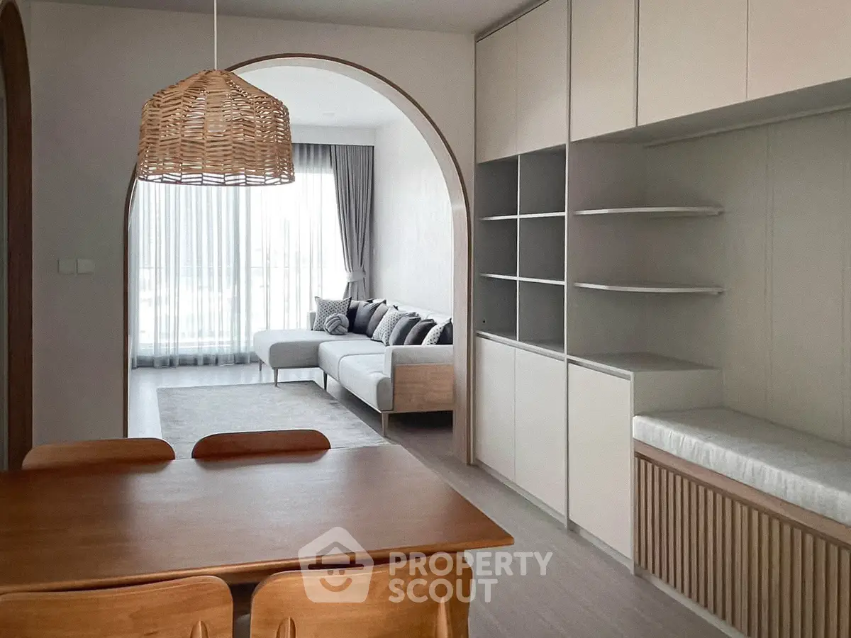 Modern open-plan living room with stylish dining area and cozy seating.