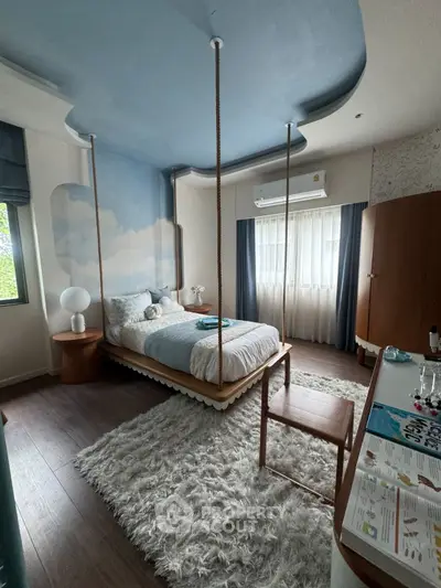 Charming bedroom with unique suspended bed and cozy decor
