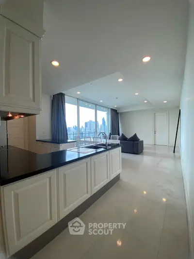 Spacious modern living room with city view and open kitchen layout