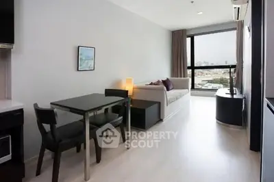Modern living room with sleek furniture and city view, perfect for urban living.
