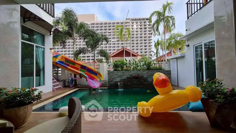 Luxurious villa with private pool and vibrant slide, perfect for family fun and relaxation.