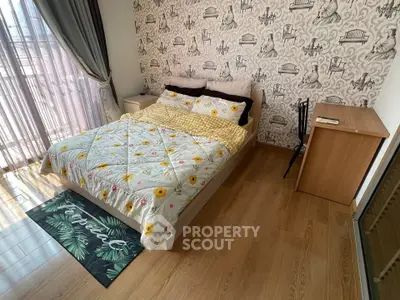 Charming bedroom with stylish wallpaper and cozy bedding, perfect for relaxation.